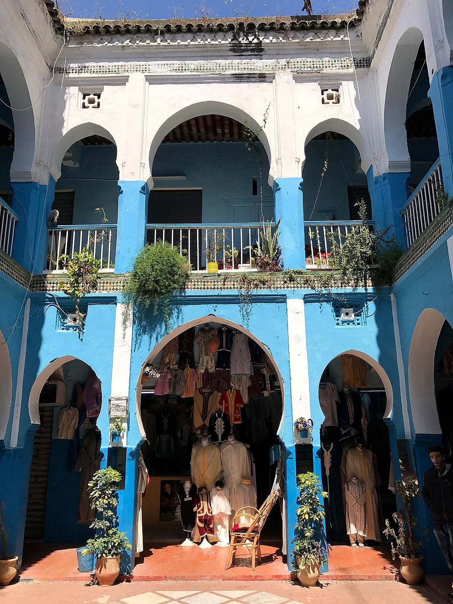 A blue-and-white courtyard with arches