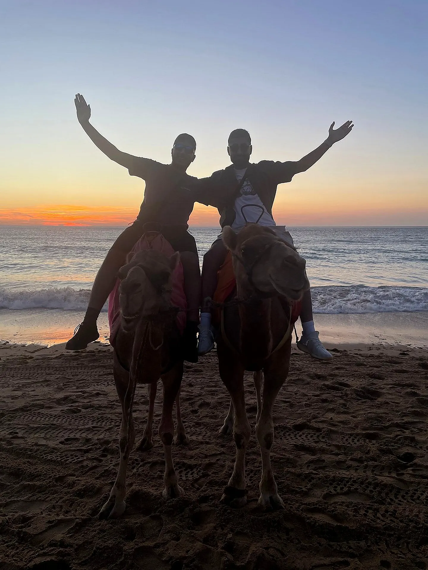A camel ride on the beach at sunset