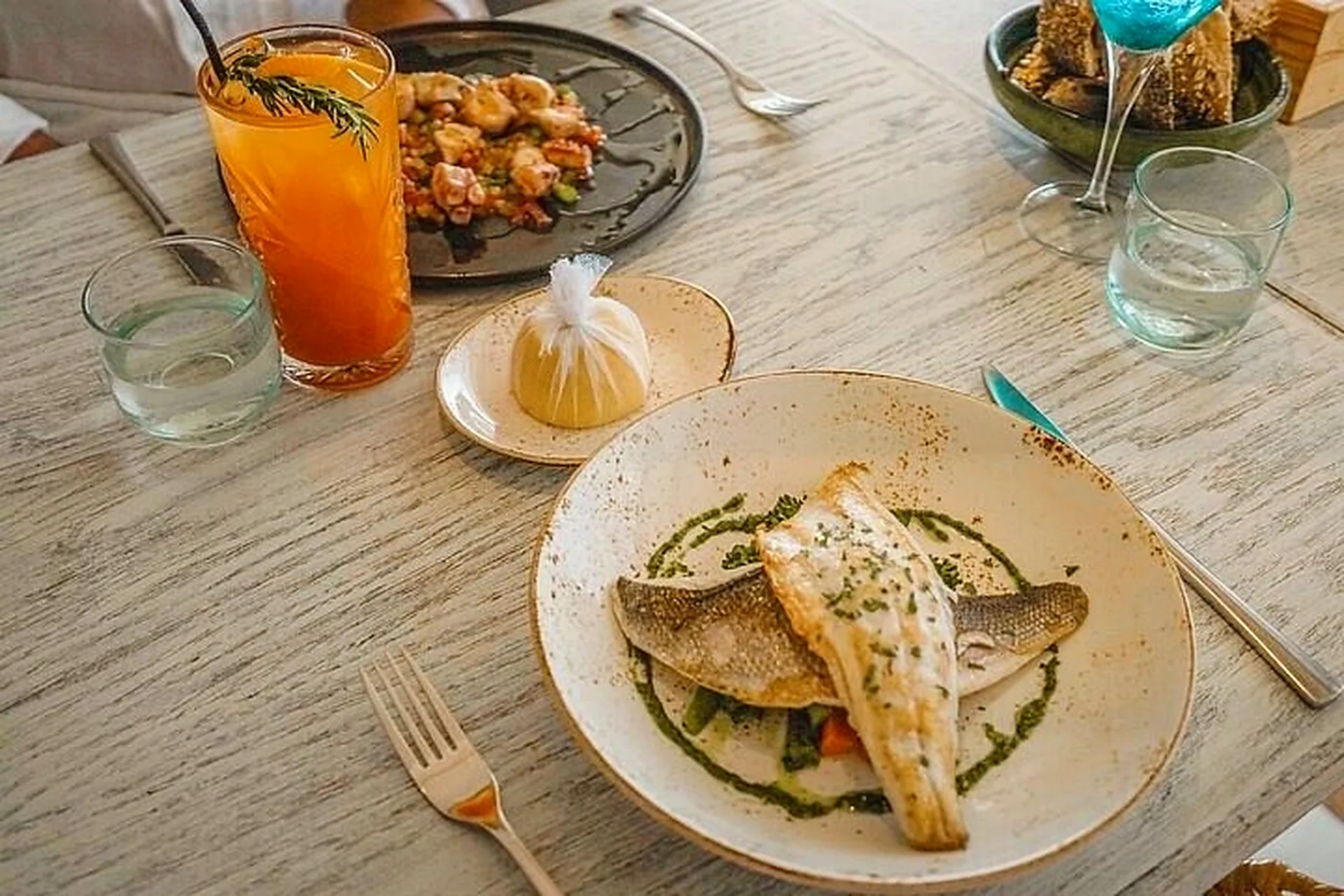 A fish dish and fresh drinks at lunch