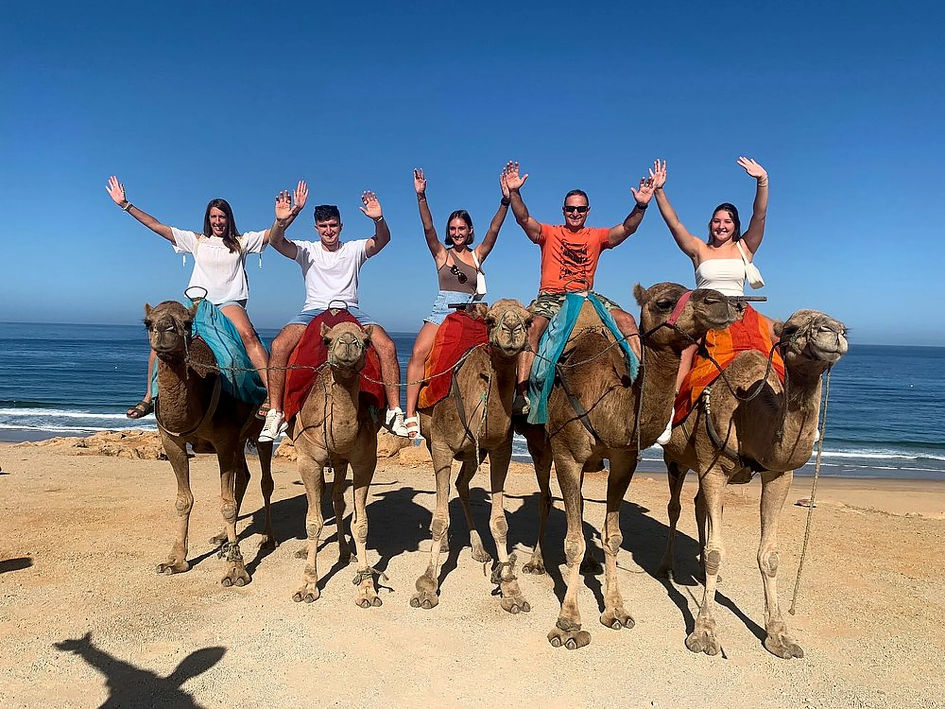 Guests on a camel ride on the beach
