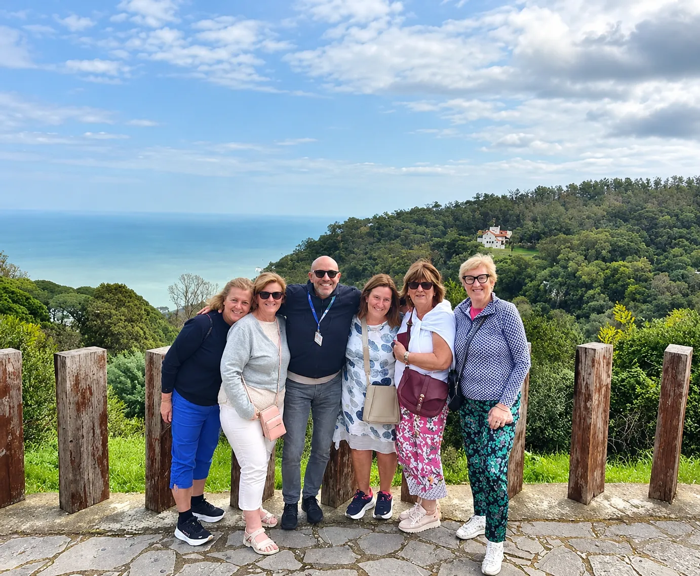 Guests with their guide at a viewpoint above the sea