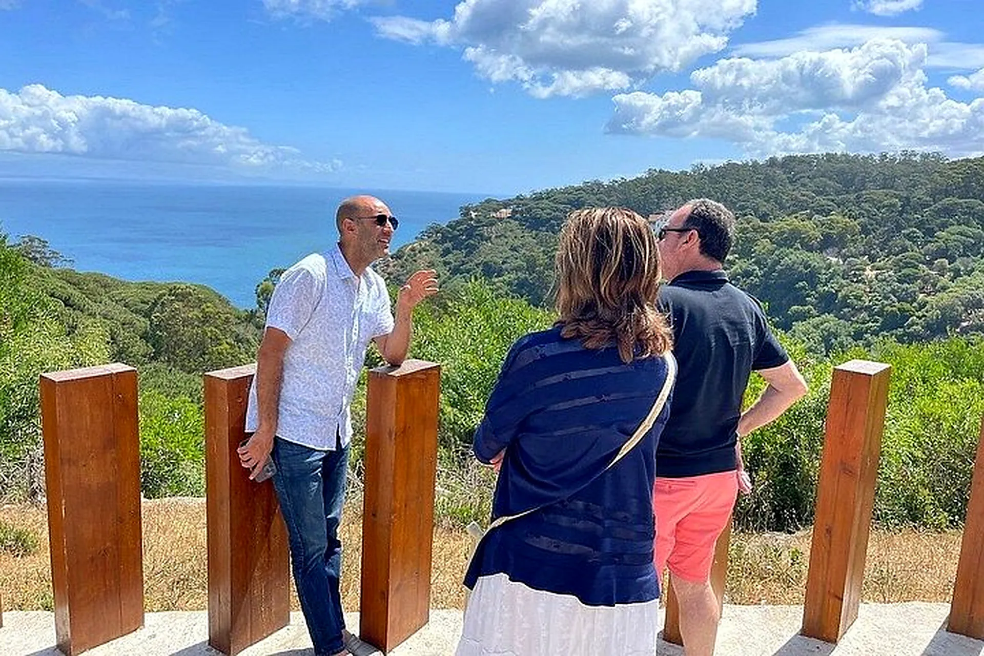 The guide pointing out the view to guests above the sea