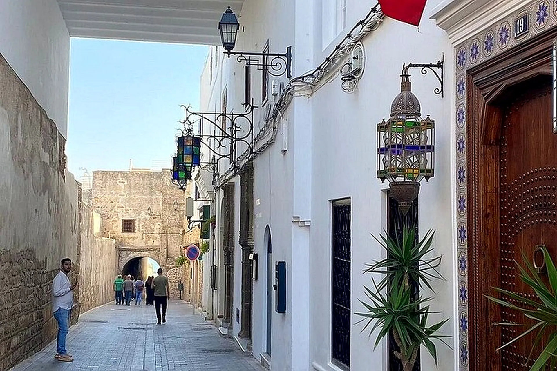 A whitewashed Medina lane leading to an arched gate